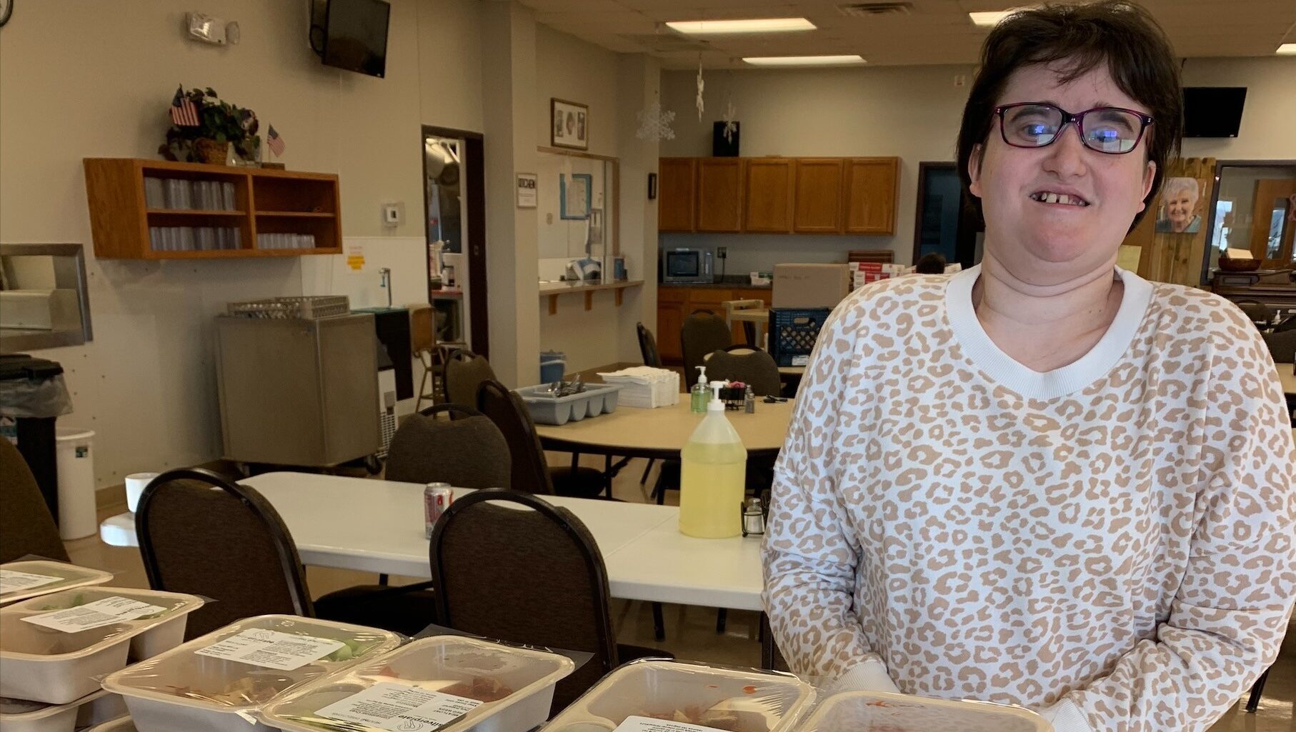 A woman packing Meals on Wheels lunches for the Senior Center.